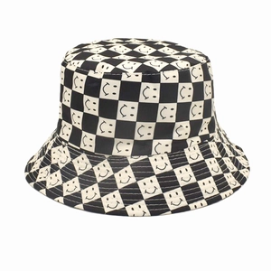 Detailed view of black and white checkerboard pattern with smile prints on a bucket hat