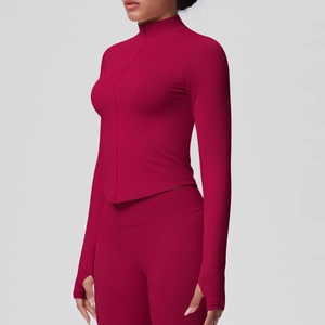 Detail of burgundy long sleeve sports top with stand collar, zipper and thumb holes