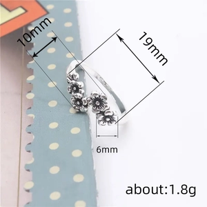 Silver vintage open ring featuring five small daisy flowers with antique finish