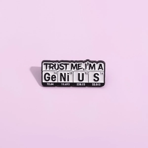 Black and white enamel chemistry science badge brooch with element symbols on purple background