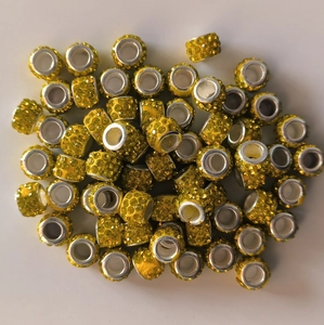 Detailed close-up of yellow rhinestone-encrusted large hole beads for DIY jewelry making
