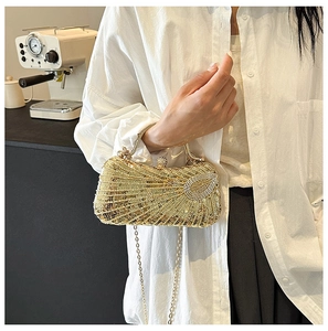 Close-up of gold sequin handbag with metallic clasp and chain strap in a cafe setting