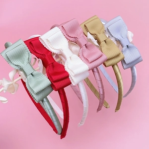 Detail of colorful grosgrain ribbon bow headbands showing texture and premium stitching