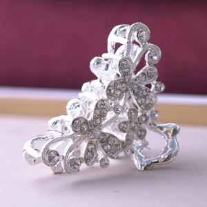 Detailed macro view of a silver alloy hair claw clip with crystal butterfly patterns