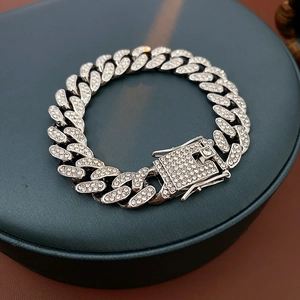 Close-up of a silver Cuban chain bracelet with sparkling rhinestones and box clasp
