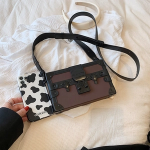 Vintage box-style crossbody bag in brown leather with black rivets and metal buckle