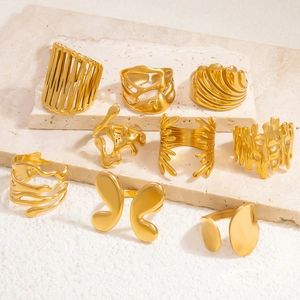 Flat lay of nine different 18k gold plated stainless steel rings with artistic textures