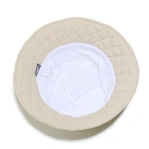 Detail view of the quilted checkered bucket hat featuring inner lining and adjustment string
