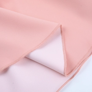Detailed view of pink fabric texture and high-quality hem stitching on long sleeve dress