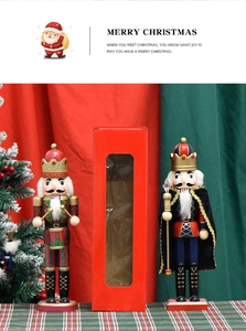 Detail of wooden nutcracker soldier set with drum and scepter in festive gift packaging