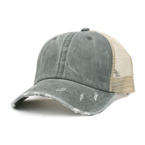 Close-up of vintage washed gray trucker hat with distressed details and beige mesh