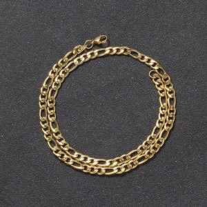Detailed view of golden 5mm Figaro link chain with secure lobster clasp on black background