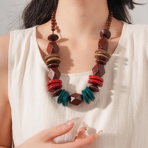 Detailed close-up of ethnic beaded necklace with brown and green geometric wooden beads