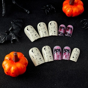 Halloween blood splatter press-on nails with black letters and pumpkin decor