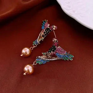 Vintage bird pendant earrings with colorful rhinestones and elegant gold brown pearls
