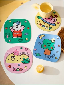 Macro detail of four colorful diatom mud coasters with cute plant and animal patterns