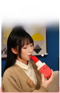 Detailed view of lipstick plush toy featuring a bright red top and smiling face embroidery