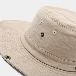 Detail of reinforced stitching and copper eyelets on a khaki outdoor safari hat