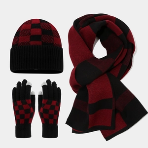 Close-up of red and black buffalo plaid knit set including beanie, scarf and touch gloves