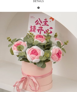 Close-up of crochet rose bouquet in pink gift box with a Happy Luck Day greeting card