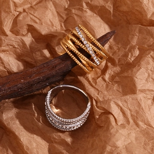 Detailed view of 18K gold plated multi-layer crisscross rings with sparkling rhinestones