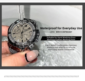 Close-up of silver quartz watch being tested under running water to show waterproof function