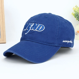 Close-up of royal blue cotton baseball cap featuring 3D letter WEND embroidery on the front