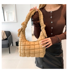 Detail of khaki quilted puffer shoulder bag with side knot handle and puffy cloud design