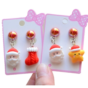 Cute Christmas clip-on earrings for girls featuring Santa Claus, stocking and star designs