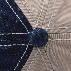 Macro view of vintage polar bear baseball cap with blue denim and khaki stitch details