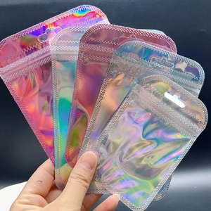 Detailed view of iridescent laser resealable bags in various sizes held by hand