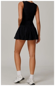 Detail of black lace running dress featuring pleated hem and invisible back zipper closure