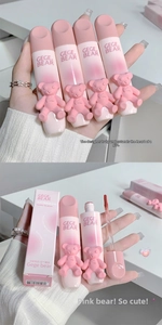 Close-up of matte velvet lip glaze tubes with cute bear relief and pink packaging boxes