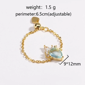 Detailed technical view of adjustable gold chain ring with mint green teardrop stone