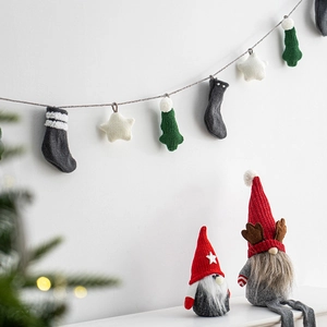 Knitted Christmas garland with stars, stockings, and trees featuring gnome dolls
