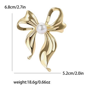 Elegant golden alloy bow brooch with central pearl ornament showing dimensions and weight