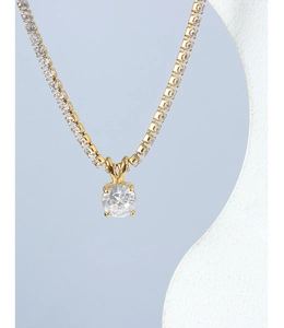 Detail of 18K gold plated tennis chain necklace featuring a round solitaire diamond pendant