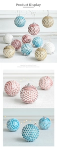 Detailed view of lace textured Christmas balls in blue, pink and gold for festive decor