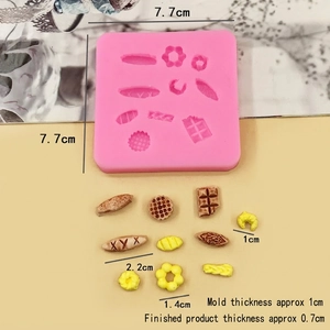 Detailed size view of pink silicone mold with mini croissant and waffle food shapes