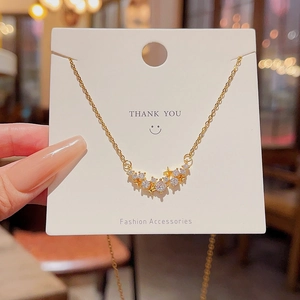 Close-up of star pendant necklace with cubic zirconia on a minimalist jewelry card