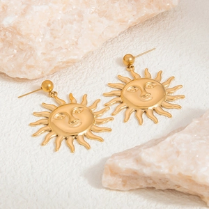 Macro detail of 18K gold plated stainless steel sun face earrings with textured finish
