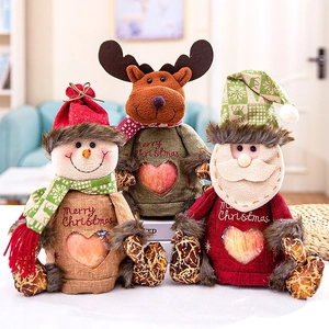 Christmas gift bags with snowman, reindeer and Santa designs featuring a heart window