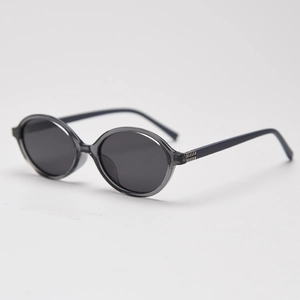 Detail view of oval retro sunglasses with grey transparent frame and dark grey lenses