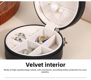 Detail of round PU leather jewelry box interior with ring slots and necklace hooks