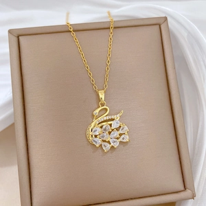 Close-up of gold swan pendant with sparkling zircon crystals on a jewelry display