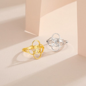Close-up of interlocking gold and silver Celtic knot rings with cut-out design
