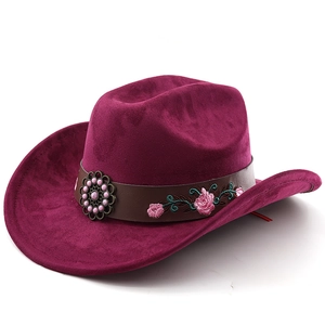 Detail of western cowboy hat with floral embroidery and pink bead on brown leather band