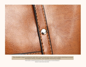 Detail view of reinforced brown leather shoulder strap with silver rivets and durable stitching
