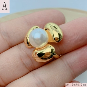Macro shot of gold floral pearl ring showing 24.7mm dimensions and liquid metal texture