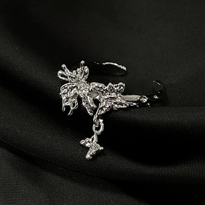 Detailed view of silver butterfly open ring with textured wings and micro-pave accents